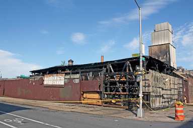 Smoky fire burns water tank factory