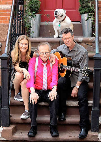 Larry King (who else?) does an interview (what else?) on a stoop (where else?)