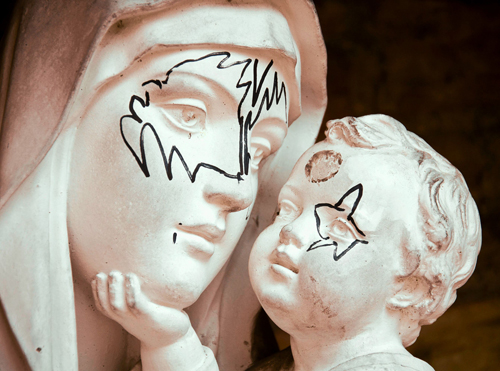Vandals draw KISS masks on Madonna and child statue