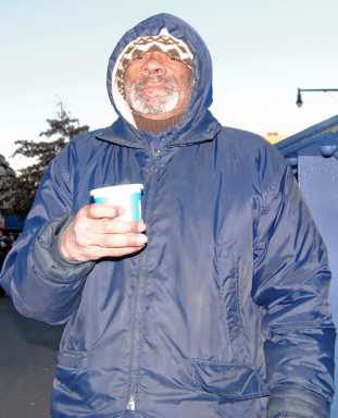 A sign of the times: Coffee the Train Man helps commuters catch the subway