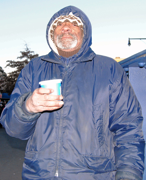 A sign of the times: Coffee the Train Man helps commuters catch the subway