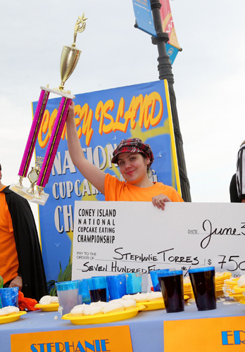 Female competitive eater destroys male gluttons in Coney cupcake contest