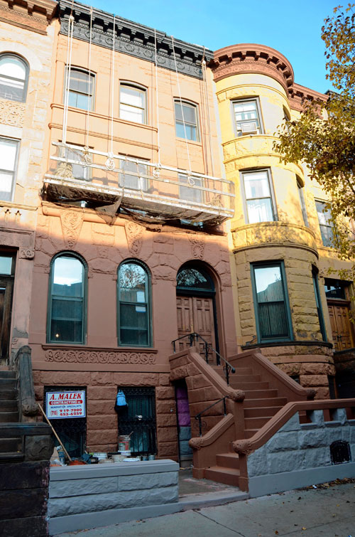 Color it theirs! New owners make pink brownstone a brown brownstone