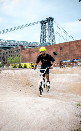 New, temporary park with bike track, small farm, and yoga classes opens at Domino site