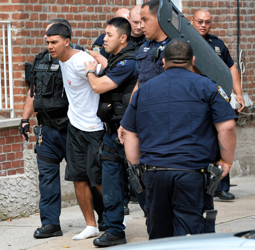 Standing by her man — in cuffs!