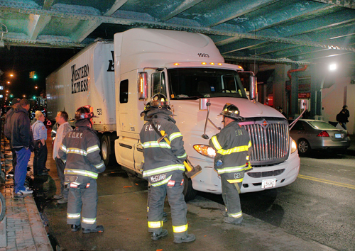 Big rig digs into train bridge