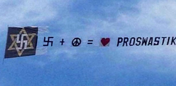 Bizarre banner flies swastika over Brighton Beach