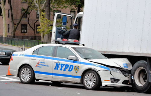 Smush-wick: Cop car crushed under truck in cyclist crash