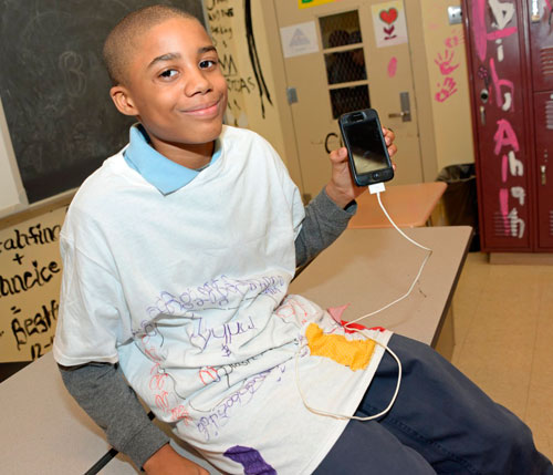 Static cling! Kids try to make cellphone charging T-shirts
