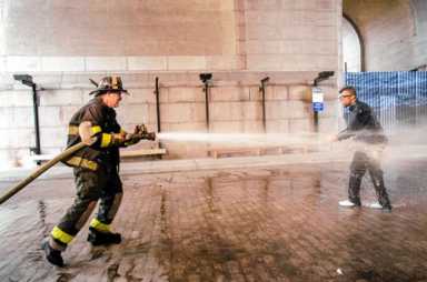 Say it and spray it: Artist endures fire-hoses’s blast for protest art
