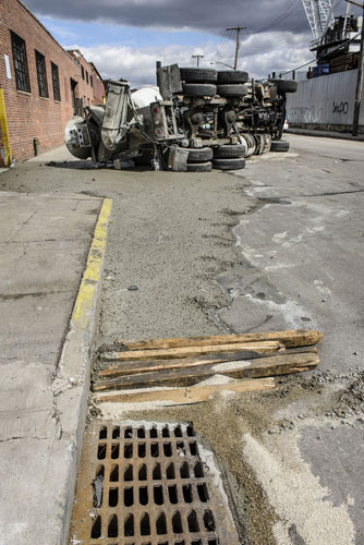 Cement truck topples over in W’burg, bystander scoops cement into pothole