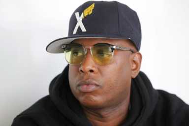 Talib Kweli DJing silent dance party in Downtown alley