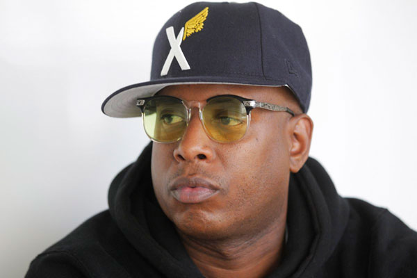Talib Kweli DJing silent dance party in Downtown alley