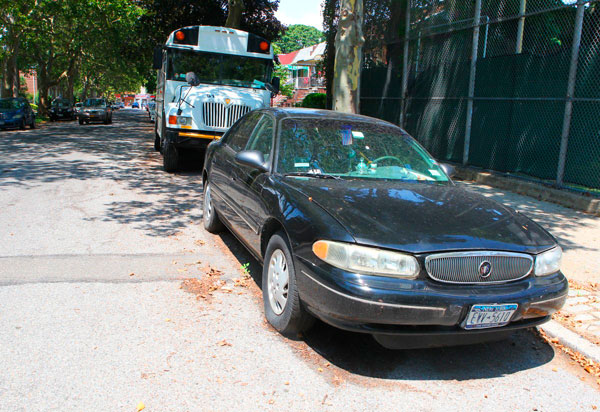 Abandoned car getting free ride in Mill Basin