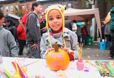 Orange bounty! Kids paint pumpkins at Court St fest