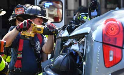 Firefighters cut trapped woman out of flipped car on Prospect Park West