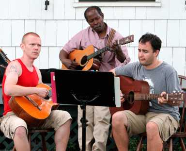 Porch pickers! Guitarists play in front of Lott House