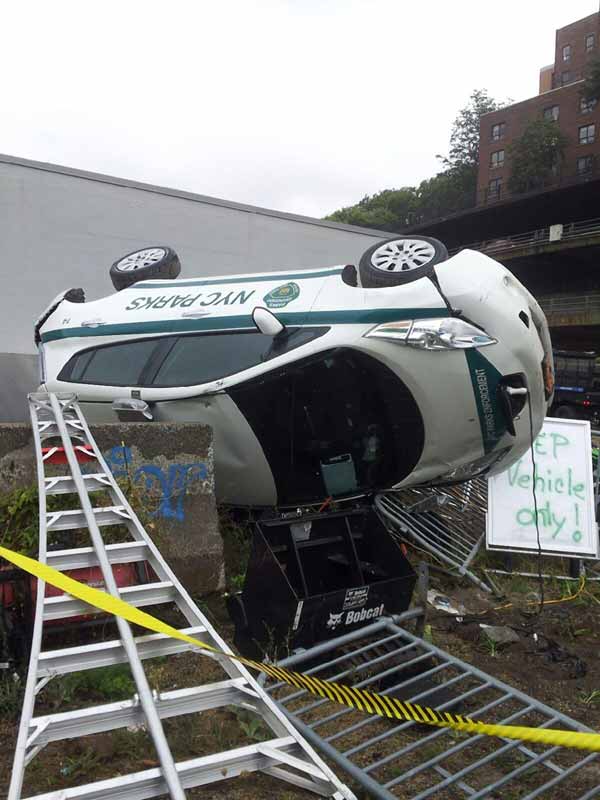 Fork it over: Vandals flip Parks Dept. car with Bobcat in Bridge Park
