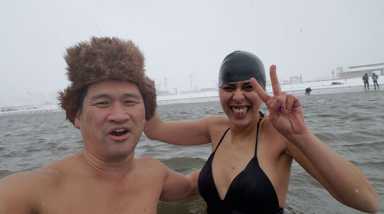 Grin and bear it! Polar Bears take mid-storm dip