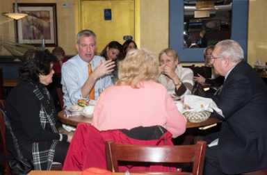 Hizzoner talks senior housing over pastrami sandwiches in Midwood