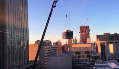 Rise of the machinery: Thrilling footage of 10-story rooftop heater installation