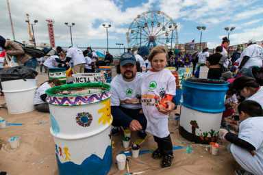 Barrels of fun! Coney Islanders paint Boardwalk trash cans