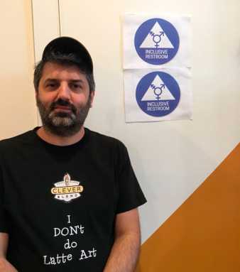 A pour choice! Café owner removes sign depicting peeping Tom from bathroom door after internet outrage