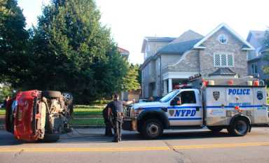 Car flips over on Avenue J