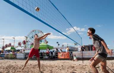 Volleyball players enjoy tourney on the beach