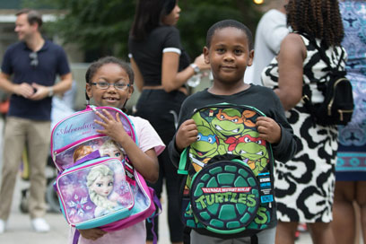 Bag grab! Local tots get brand new backpacks at giveaway