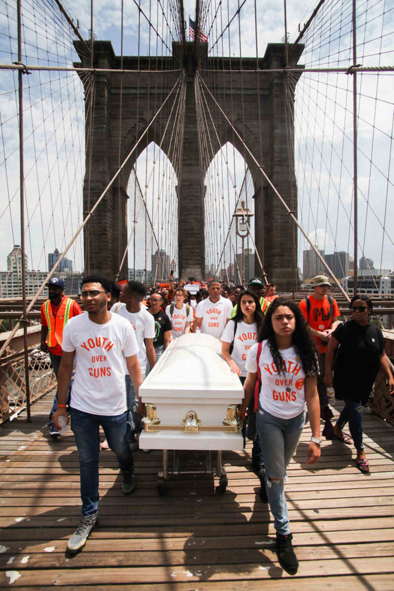 Outrage burns on Bklyn Bridge: Orange-clad protestors march across span in latest call for gun-law reform