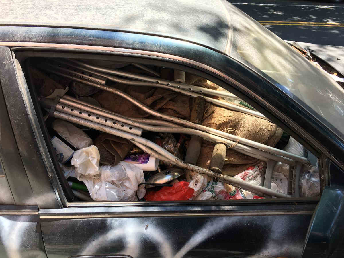 UPDATE: Cops tow jalopy filled with junk from Slope street