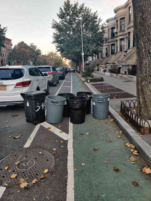 City trash collectors create garbage-can walls along Ninth Street bike lane