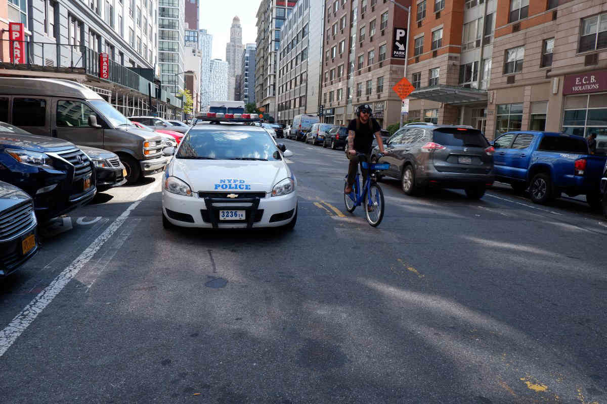‘It’s a mess’ Downtown bike lane constantly blocked by illegally parked cop cars
