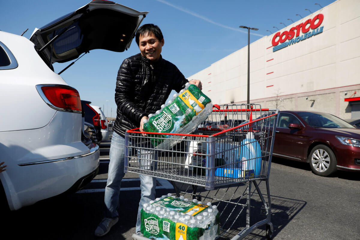 A man loads water into his car in the Costco parking lot, after the first confirmed case of coronavirus was announced in New York State in the Brooklyn
