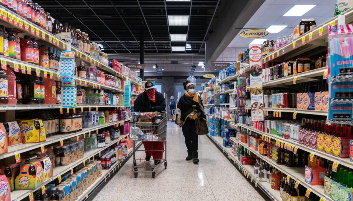 Shoppers browse in a supermarket while wearing masks in St Louis