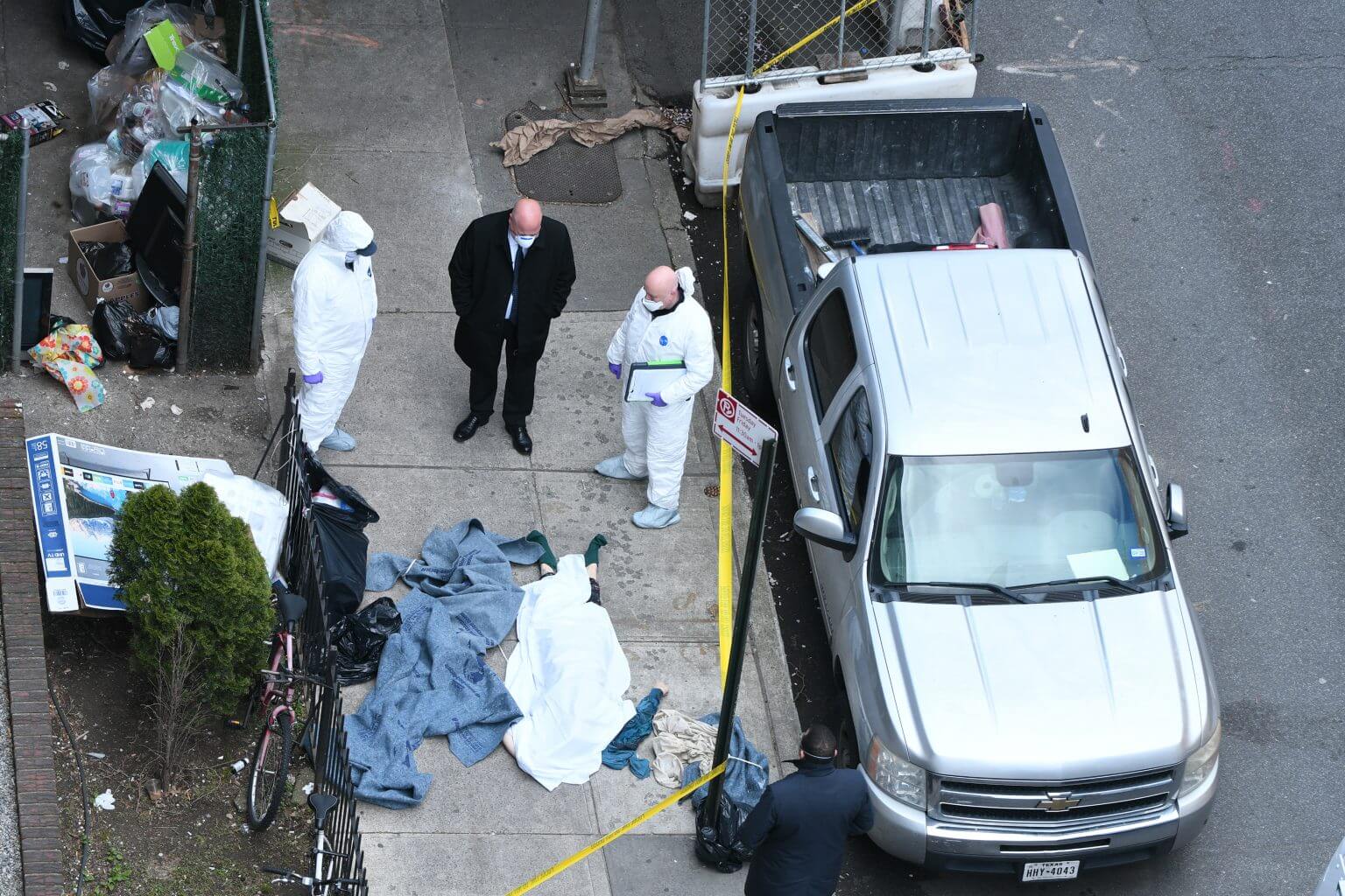 Man in custody after woman’s body found wrapped in tarp and dumped on