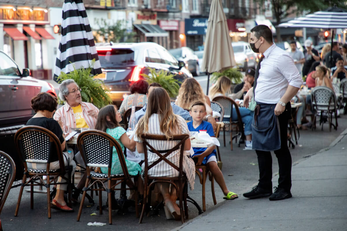 People dine in parking spaces on the street outside CEBU restaurant on the first day of the phase two re-opening of businesses following the outbreak of the coronavirus disease (COVID-19) in Brooklyn, New York