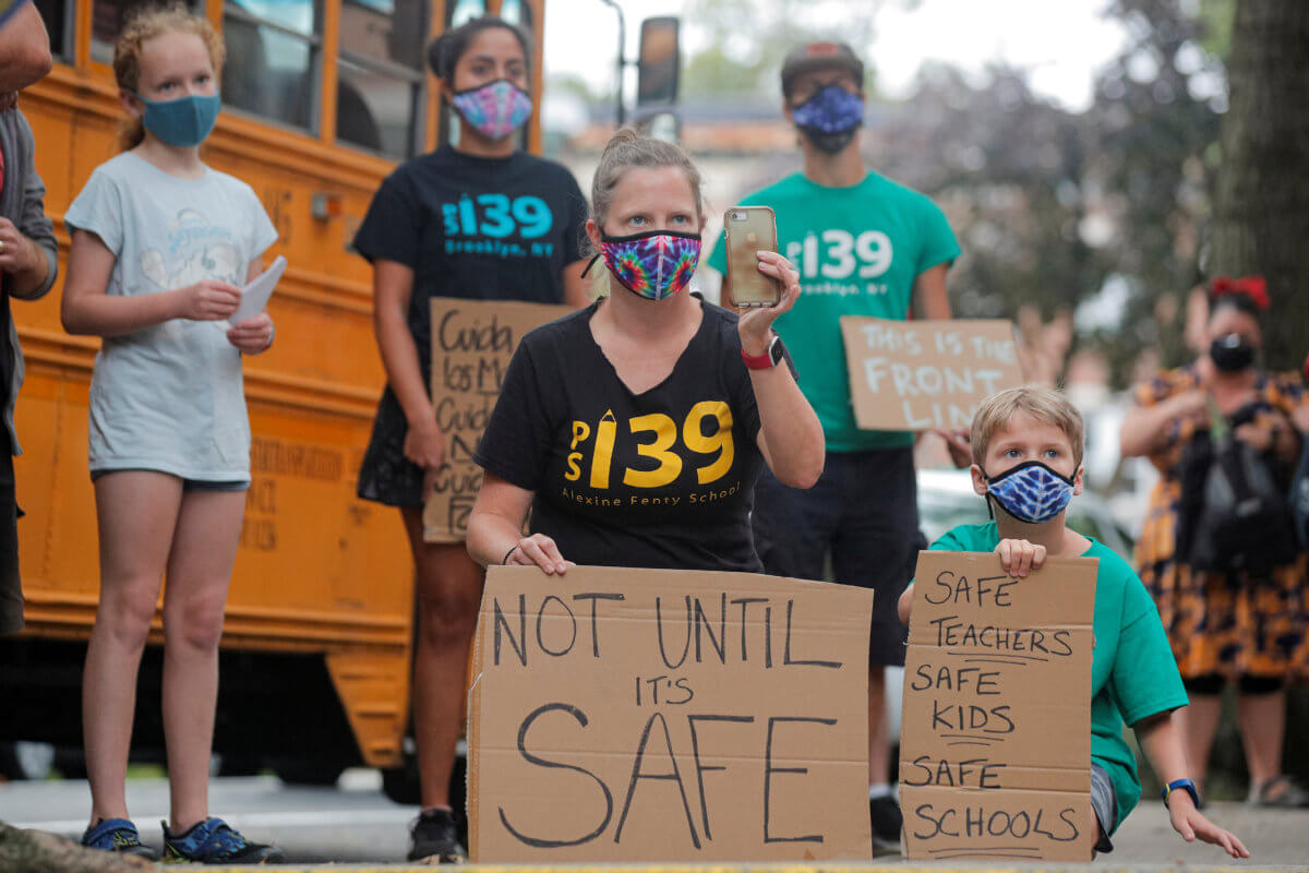 Parents and children protest the opening of schools in Brooklyn, New York