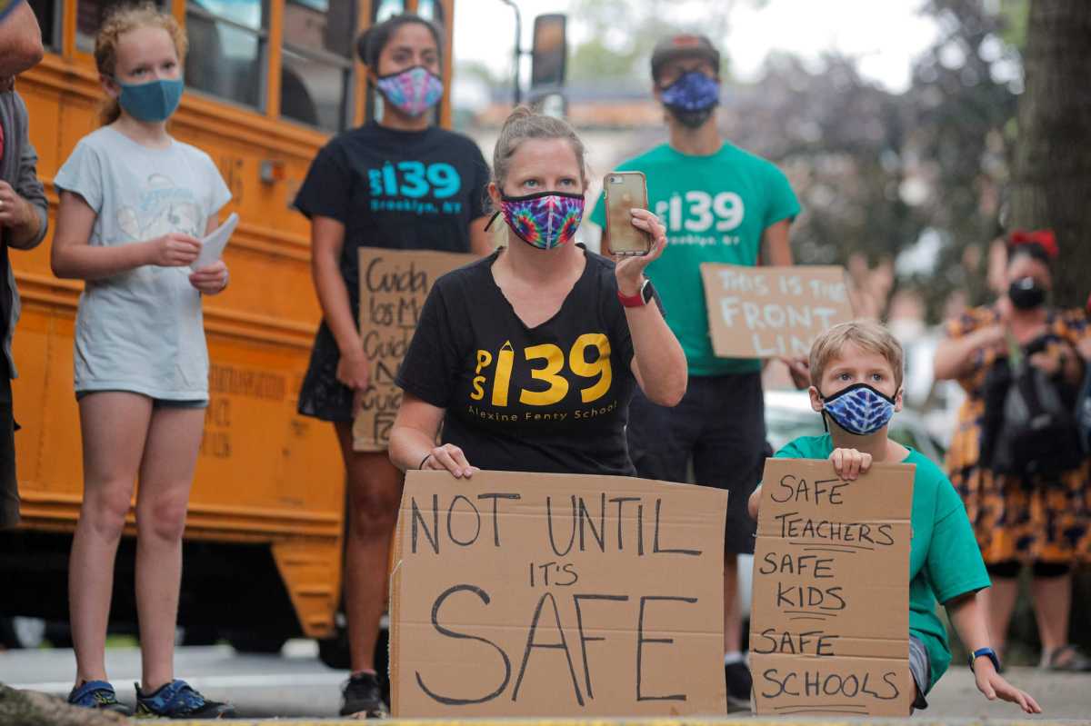 Parents and children protest the opening of schools in Brooklyn, New York