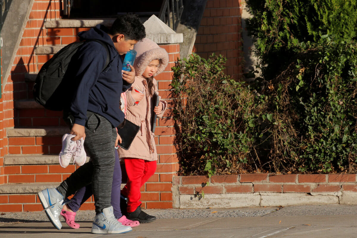FILE PHOTO: Students exit a school following the announcement to close New York City public schools, as the spread of coronavirus disease (COVID-19) continues to rise, in Brooklyn, New York