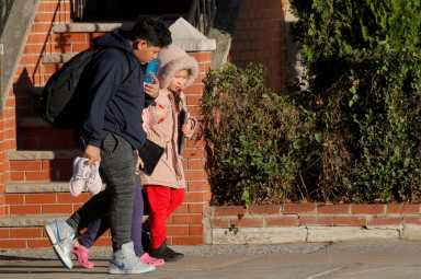 FILE PHOTO: Students exit a school following the announcement to close New York City public schools, as the spread of coronavirus disease (COVID-19) continues to rise, in Brooklyn, New York