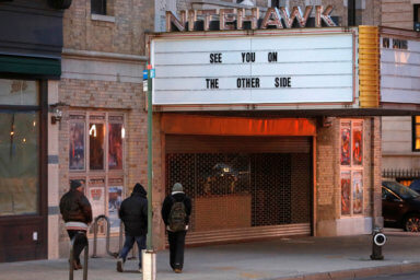 People walk by the Nitehawk cinema, which closed due to the coronavirus disease (COVID-19), in Brooklyn, New York City