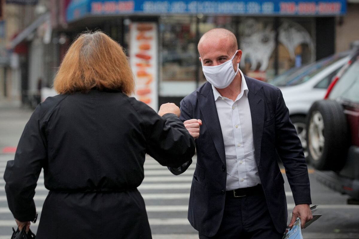 U.S. Representative Max Rose (D-NY) greets a supporter as he campaigns in Brooklyn, New York