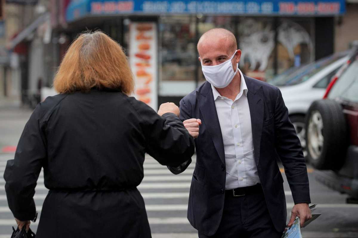 U.S. Representative Max Rose (D-NY) greets a supporter as he campaigns in Brooklyn, New York