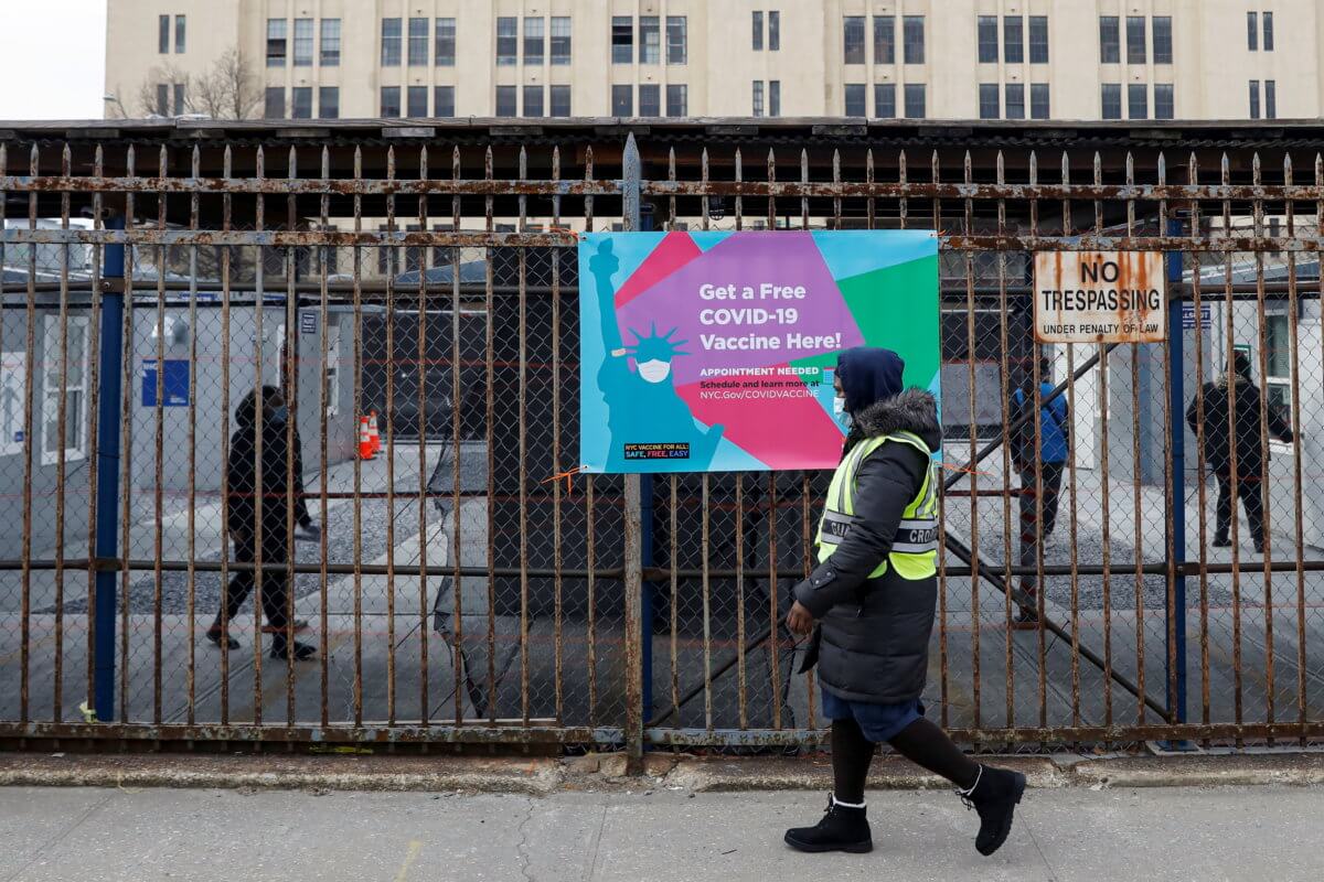 People are seen inside a 24 hour coronavirus disease (COVID-19) vaccination center at the Brooklyn Army Terminal in Brooklyn, New York
