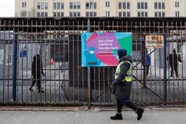 People are seen inside a 24 hour coronavirus disease (COVID-19) vaccination center at the Brooklyn Army Terminal in Brooklyn, New York