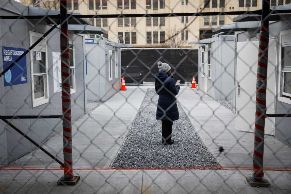 A woman waits to receive a dose of the coronavirus disease (COVID-19) vaccine at a 24 hour vaccination center at Brooklyn Army Terminal in Brooklyn, New York
