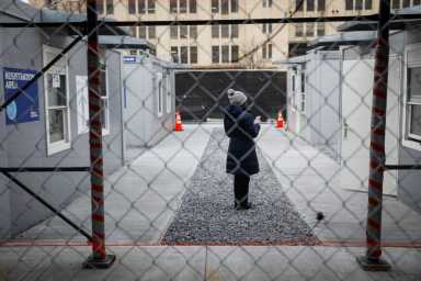 A woman waits to receive a dose of the coronavirus disease (COVID-19) vaccine at a 24 hour vaccination center at Brooklyn Army Terminal in Brooklyn, New York