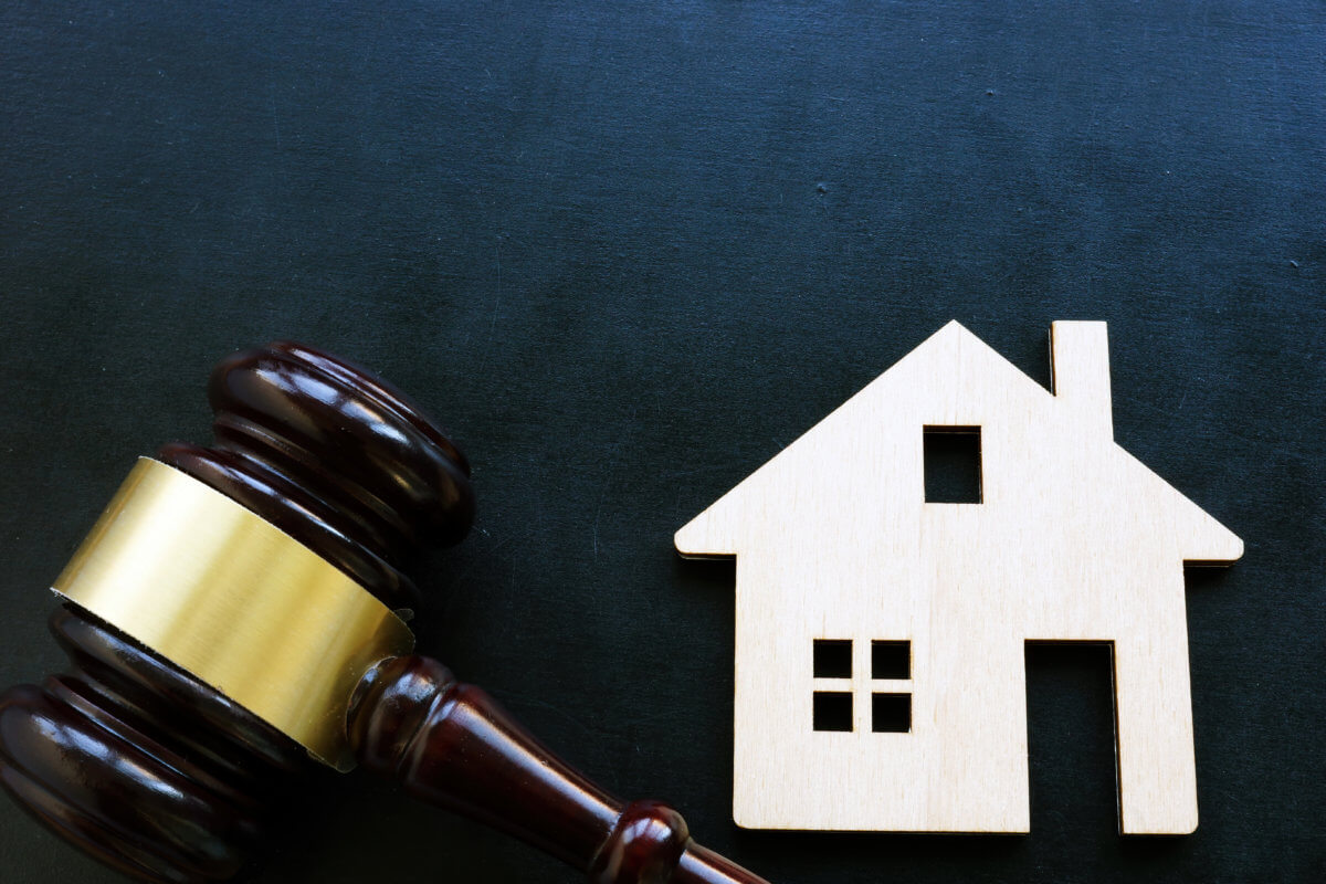Real estate law concept. Home as symbol of property and gavel.
